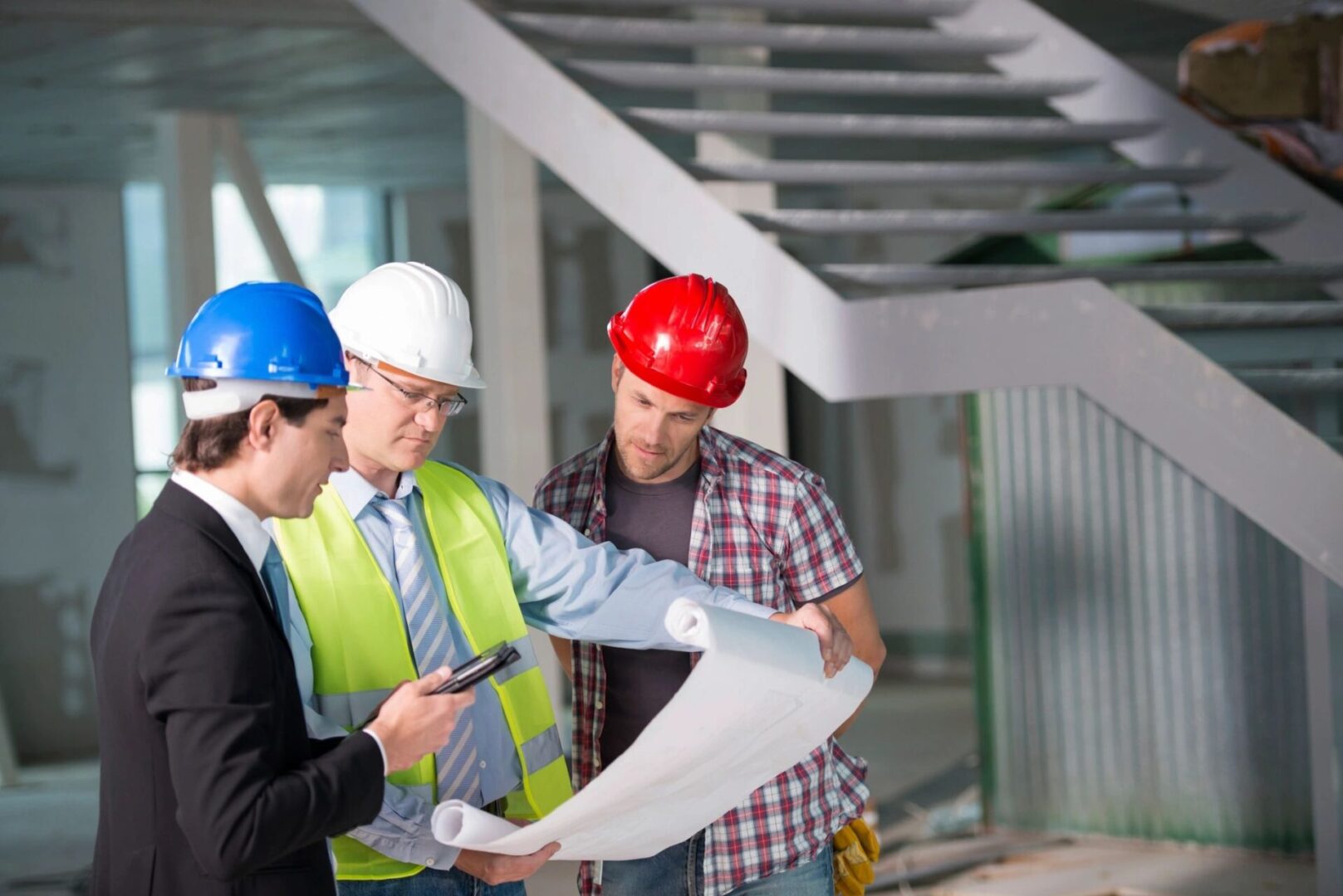 Construction Team Reviewing Blueprints Together